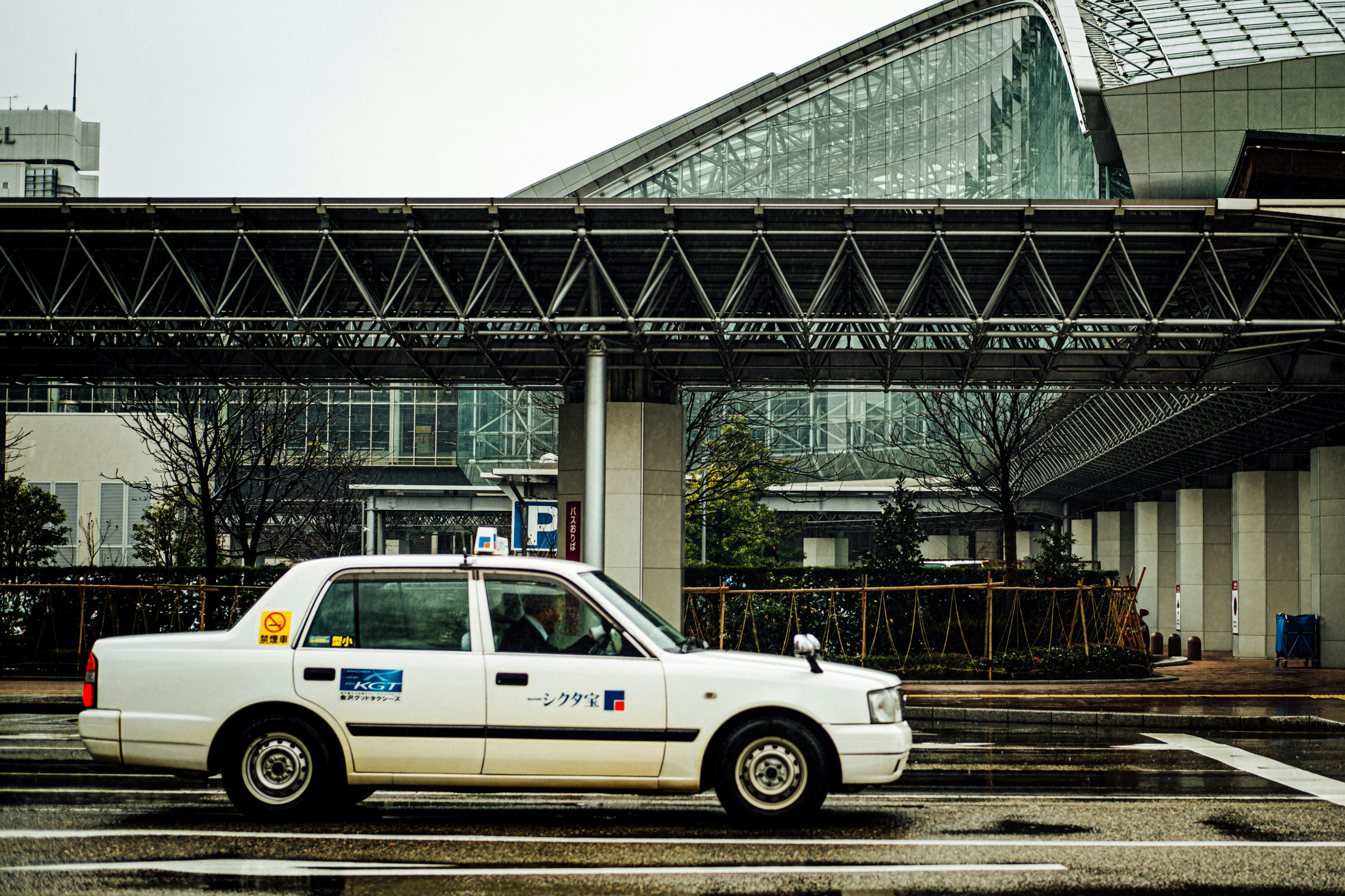 white taxi sedan on roadway